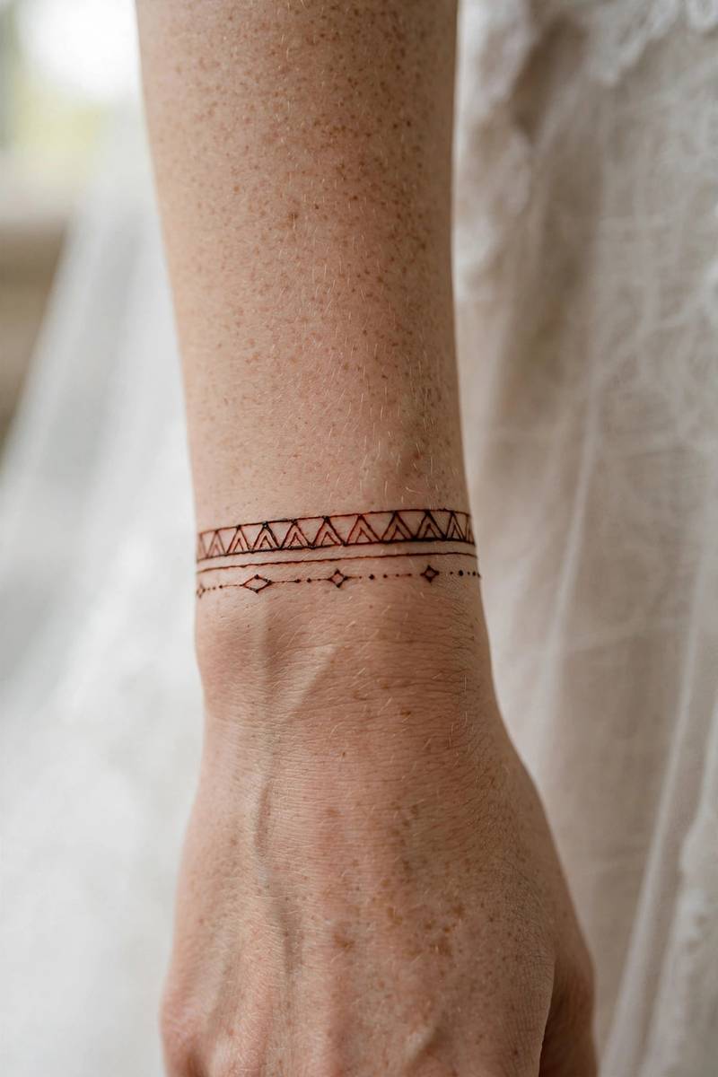 Minimal bridal henna wrist cuff of thin geometric lines and dots
